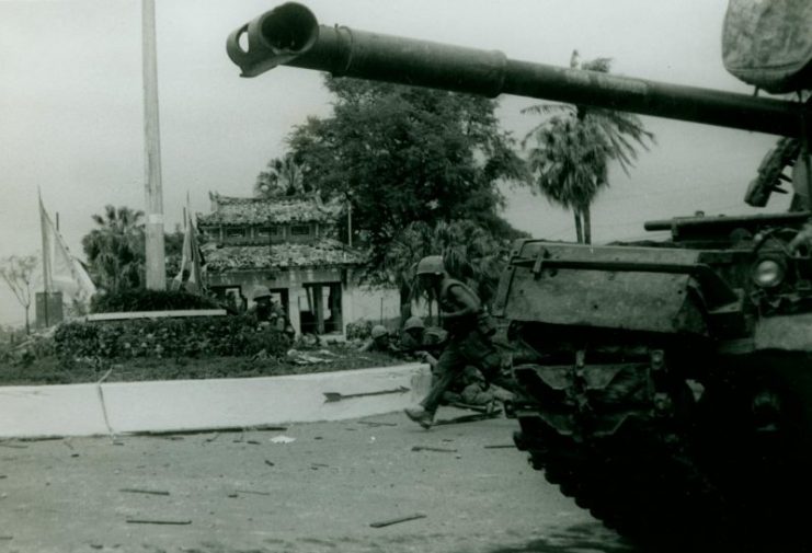U.S. Marines advance past an M48 Patton tank during the battle for Huế