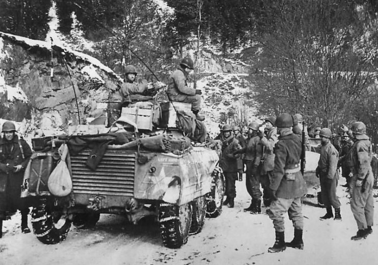 Patrols of the U.S. First and Third armies are shown as they met near the town of Grinvet, west of Houffalize, Belgium, during the Battle of the Bulge.