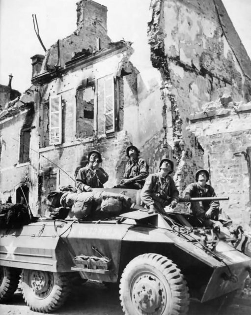 US Soldiers of Recon Unit in M8 Scout Car In Mountebourg France.