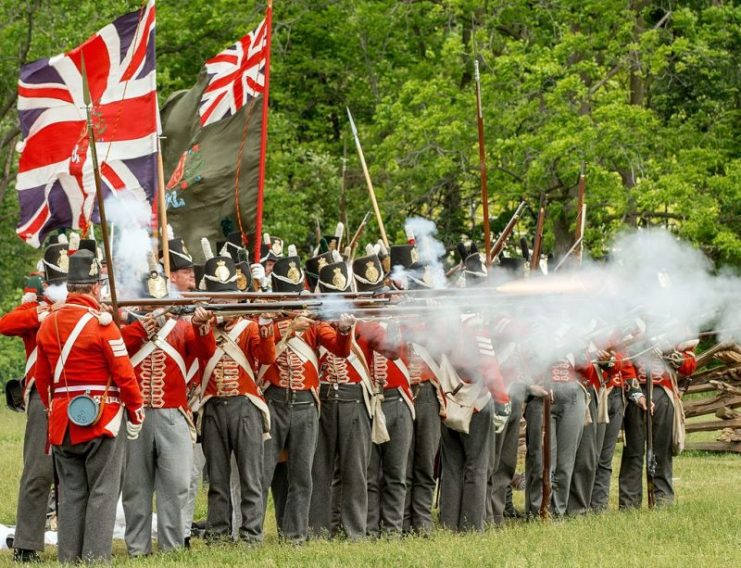 Re-enactors in UK uniforms fire muskets toward the “Americans” in this annual commemoration of the June 6, 1813 Battle of Stoney Creek. By Peter K Burian / CC BY-SA 4.0