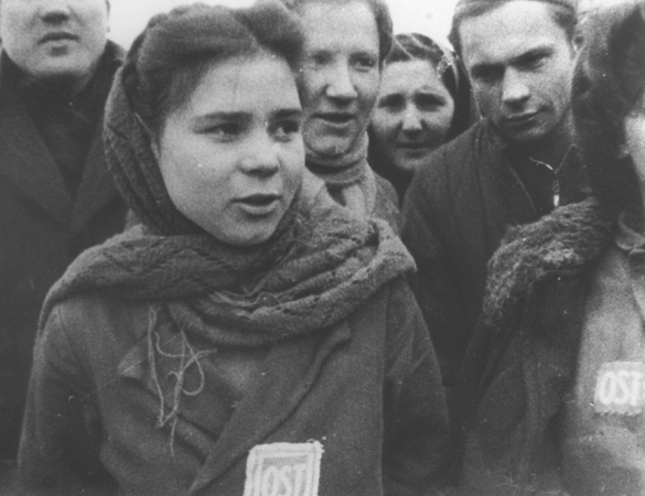 Female forced laborers wearing “OST” (Ostarbeiter) badges are liberated from a camp near Łódź.