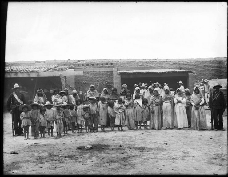 Yaqui Indian prisoners under guard, Guaymas, Mexico, ca.1910