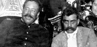 Pancho Villa (left), commander of the División del Norte (Division of the North), and Emiliano Zapata, commander of the Ejército Libertador del Sur (Liberation Army of the South). Villa is sitting in the presidential throne in the Palacio Nacional. Both men broke with Carranza.