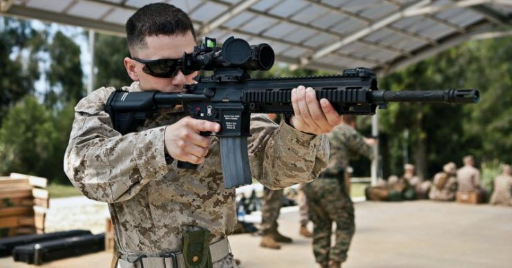 A U.S. Marine armed with an M27 IAR affixed with ACOG Squad Day Optic.