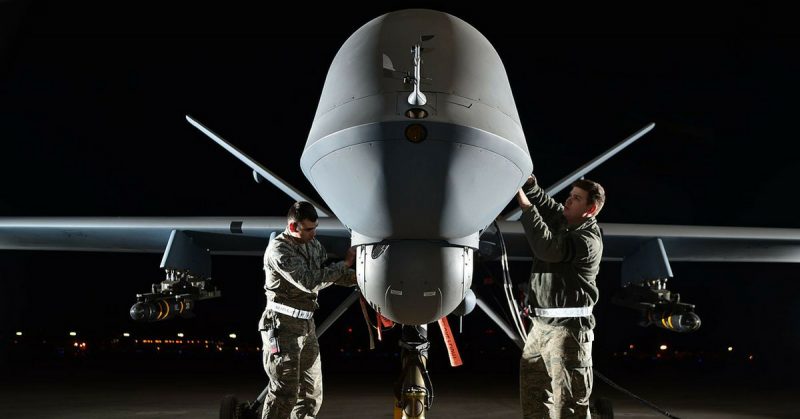 Airman 1st Class Steven (left) and Airman 1st Class Taylor prepare an MQ-9 Reaper for flight during exercise Combat Hammer, May 15, 2014, at Creech Air Force Base, Nev. 