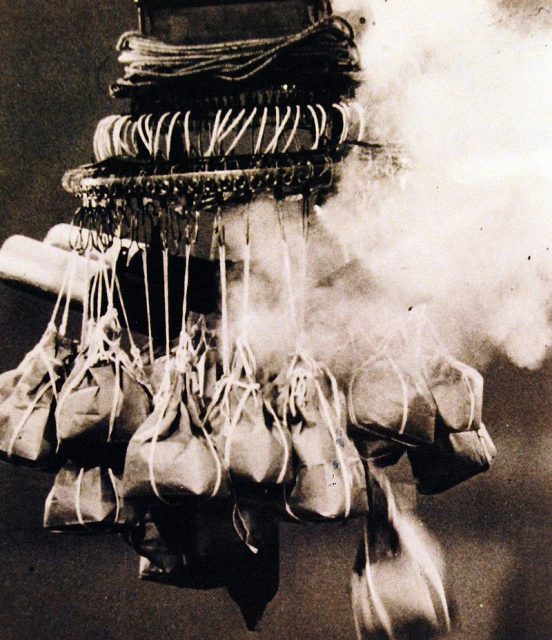 The bomb load of a Japanese balloon, Fu-Go, is attached to a “chandelier” with an automatic release mechanism. Exploding fuse which releases a sandbag is shown in this movie still. Here the “chandelier” is fully rigged with hangs from the center and is the last object to be released.