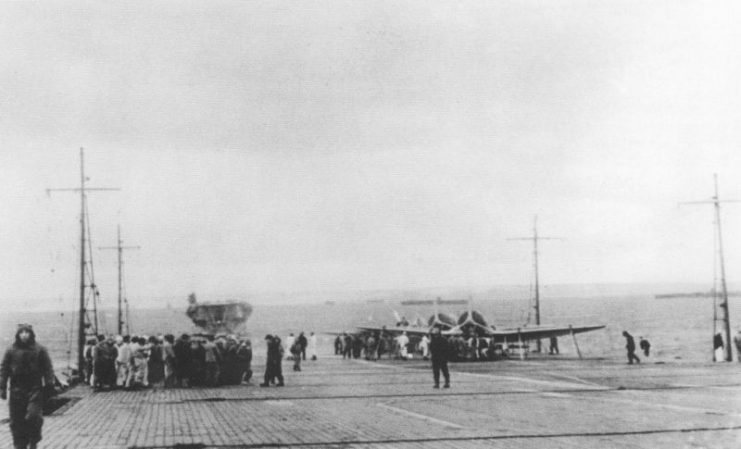 Crewmembers gather on the flight deck of Akagi at Hitokappu Bay, Kuriles in November 1941 prior to the attack on Pearl Harbor. The other carriers in the background are, from left to right: Kaga, Shōkaku, Zuikaku, Hiryū, and Sōryū.