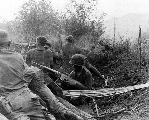 Men of the 1st Brigade, 101st Airborne Division (Screaming Eagles) fire from old Viet Cong trenches