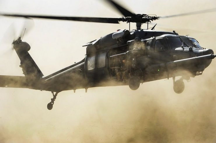 A U.S. Air Force HH-60G Pave Hawk helicopter assigned to the 303rd Expeditionary Rescue Squadron (ERQS) picks up pararescuemen with the 82nd ERQS and simulated patients during a combat search and rescue exercise in Djibouti March 23, 2013