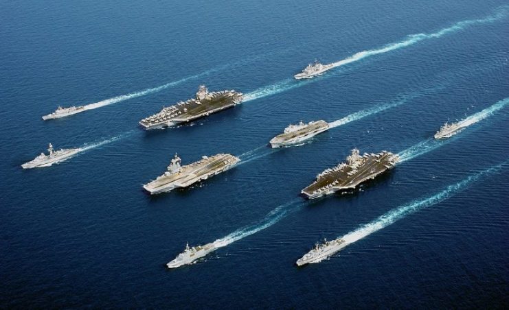 A flotilla of ships including 3 aircraft carriers.