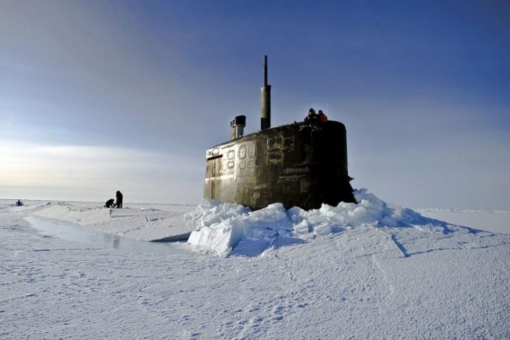 U.S. Navy sailors and members of the Applied Physics Laboratory Ice Station clear ice from the hatch of the USS Connecticut (SSN 22) as it surfaces above the ice in the Arctic Ocean on March 19, 2011. The submarine and crew are participating in Ice Exercise 2011, which tests submarine operations in the Arctic.