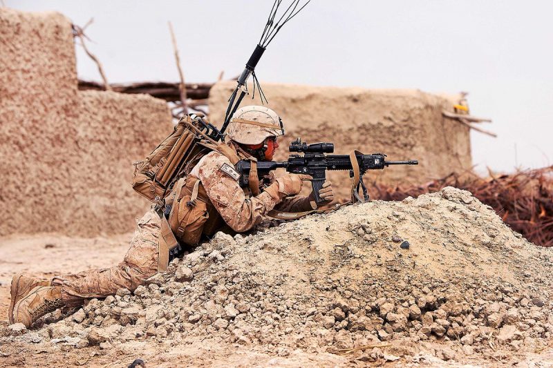 A U.S. Marine armed with an M27 fitted with a Harris bipod and a 3.5x Squad Day Optic covers his team in Afghanistan in March 2012.
