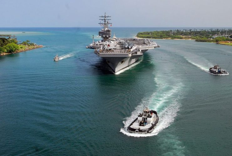 U.S. Marines and sailors man the rails aboard the aircraft carrier USS Ronald Reagan (CVN 76) as the ship transits Pearl Harbor in Hawaii on June 28, 2010