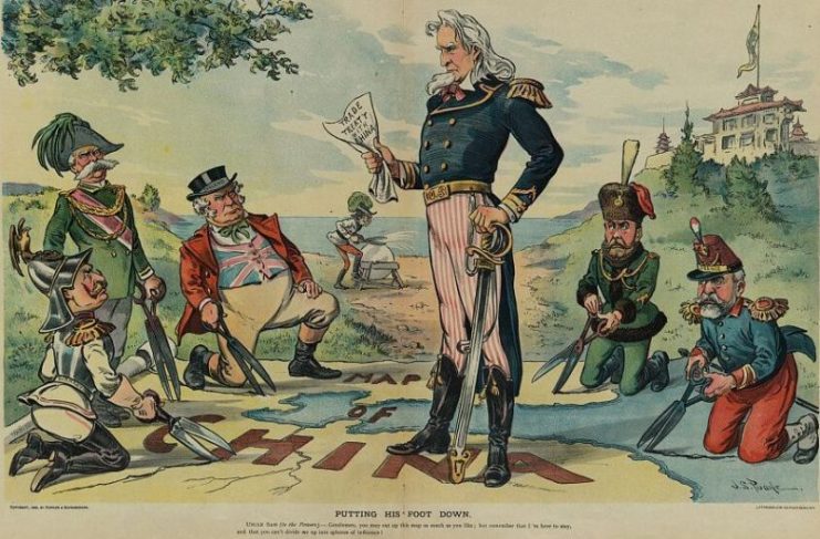 Uncle Sam stands on map of China which is being cut up by German, Italy, England, Russia, and France (Austria is in backgr. sharpening shears); Uncle Sam clutches “Trade Treaty with China” and says: “Gentleman, you may cut up this map as much as you like, but remember that I’m here to stay, and you can’t divide me up into spheres of influence”.