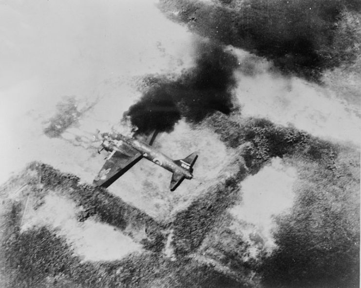 A burning Japanese Mitsubishi G4M (Allied code Betty) bomber buring during an attack by US planes, probably in the southwest Pacific, ca. 1943-1945.