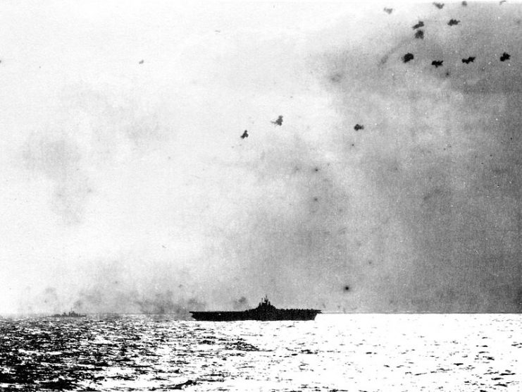 A Japanese kamikaze suicide plane (Yokosuka D4Y “Judy”?) attacks the U.S. Navy aircraft carrier USS Bunker Hill (CV-17) off Okinawa, 11 Apr 1945. It was shot down and crashed aft of the ship.