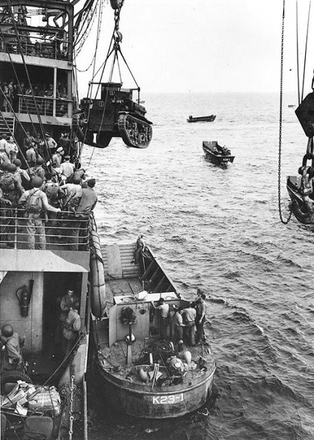A Marine Corps M2A4 is hoisted into a landing craft off Guadalcanal on the first day of landings, 7 August 1942.