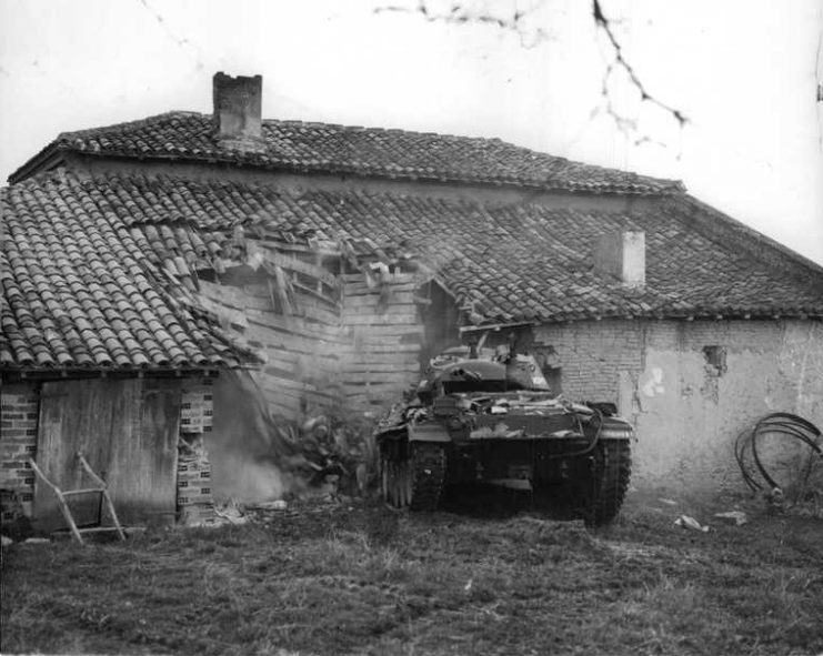 M-24 tank destroying a home.