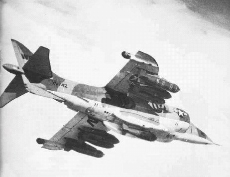 An RAF Harrier GR.1, on loan to the USMC, displaying its underside with a full load of bombs.