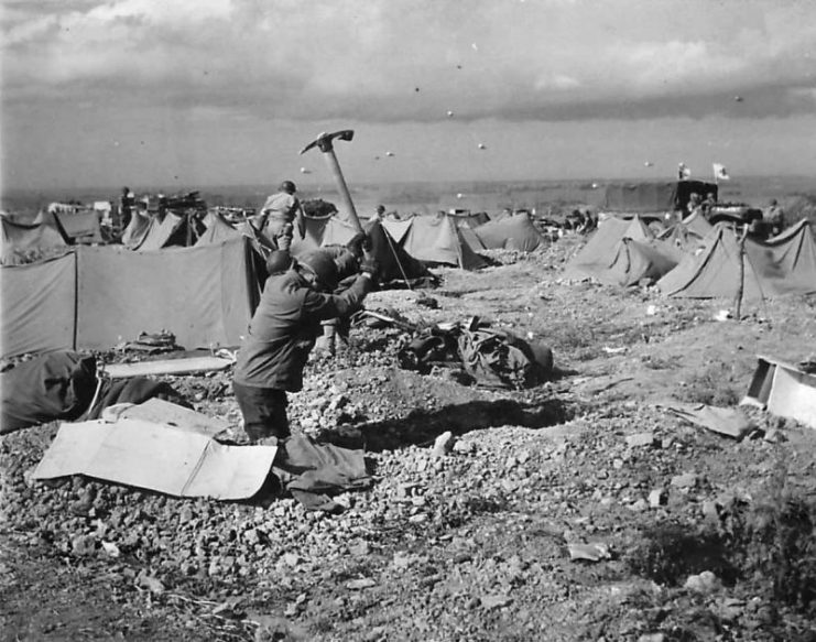 Barrage balloons overhead as US Medics dig in on D-Day beach