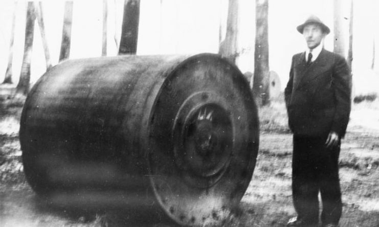 A German official stands next to an unexploded, British Upkeep bouncing bomb. The weapon was recovered from the wreckage of Avro Lancaster ED927/G ‘AJ-E’, piloted by Flt Lt Barlow. The aircraft crashed at 2350 hours on 16 May 1943 after striking power lines 5km east of Rees, Germany. All on board were killed.