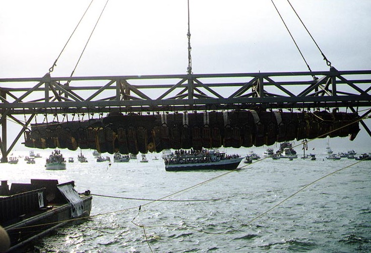 Confederate Submarine H.L. Hunley, suspended from a crane during her recovery from Charleston Harbor, 8 August 2000.