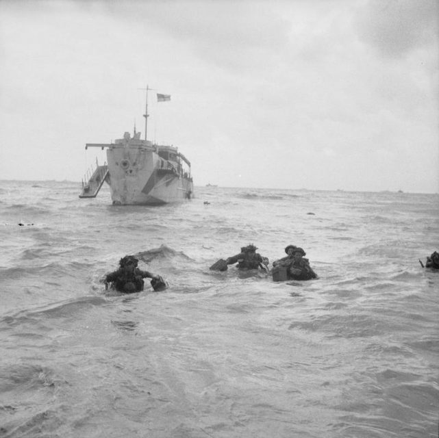 D-day – British Forces during the Invasion of Normandy 6 June 1944 Troops wading ashore from an LCI(L) on Queen beach, Sword area, 6 June 1944.