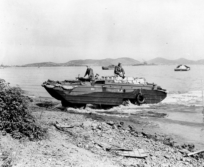 A DUKW amphibious truck landing on a beach