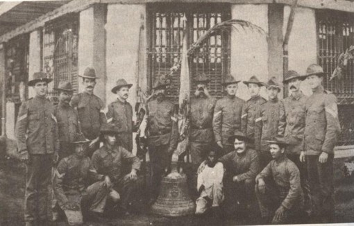 Extant photograph of some American survivors with their bell of Balangiga.