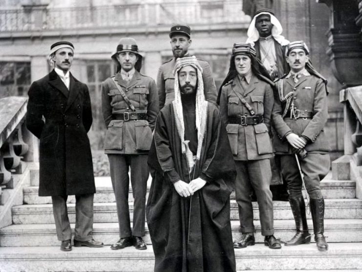 Emir Faisal’s delegation at Versailles, during the Paris Peace Conference of 1919. Left to right: Rustum Haidar, Nuri as-Said, Prince Faisal, Captain Pisani (behind Faisal), T. E. Lawrence, unknown member of his delegation, Captain Tahsin Kadry.