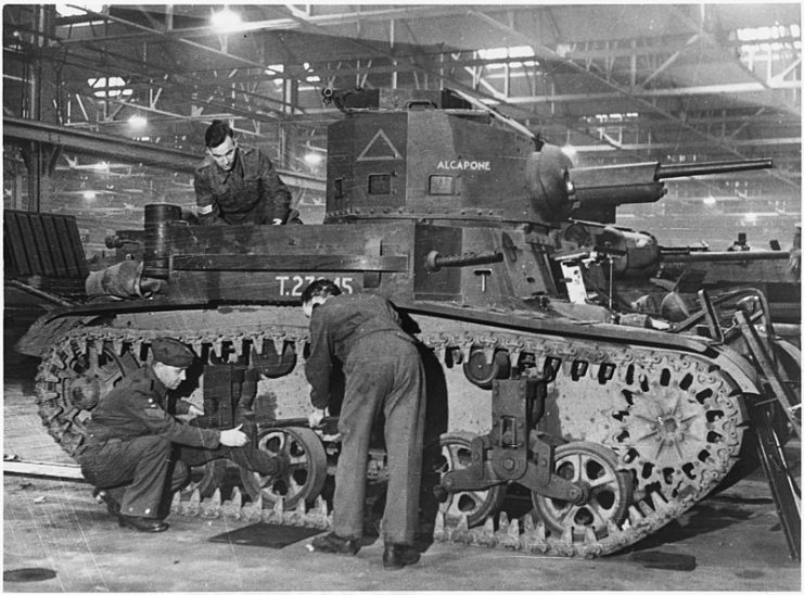 Fitters assembling an M2A4 light tank at a British ordnance depot.