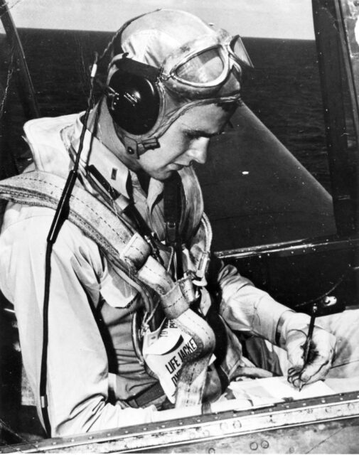 George H.W. Bush sitting in the cockpit of an aircraft