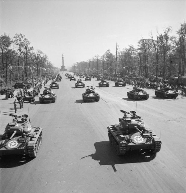 Germany Under Allied Occupation American M24 (Chaffee) Light Tanks drive down the Charlottenburg Chaussee in Berlin during the Four Nations VJ Day parade.