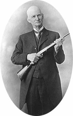 John Browning holding a Browning semi-auto .22 rimfire rifle.