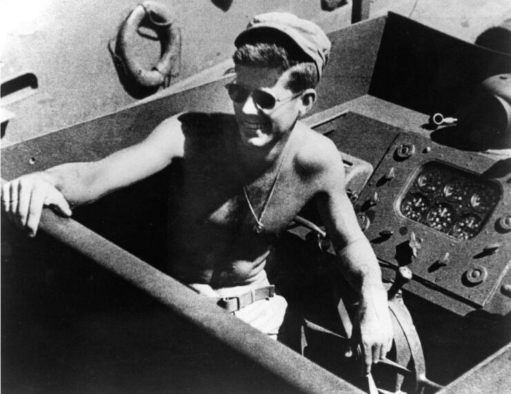 John F. Kennedy sitting in a torpedo boat