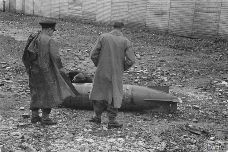 At work on a new type of bomb or torpedo dropped by parachute near Algiers. © IWM.