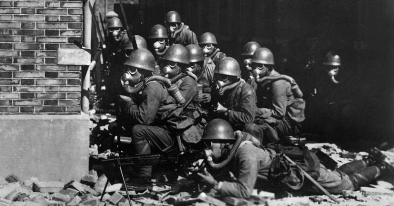 Japanese Special Naval Landing Forces with gas masks and rubber gloves during a chemical attack in China.