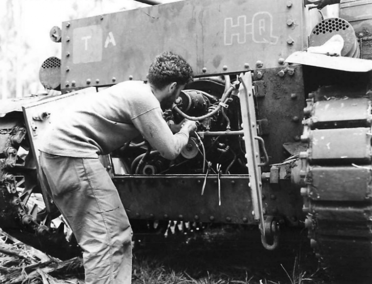 Marine tank crewman checks M2A4 engine on Guadalcanal, 1942