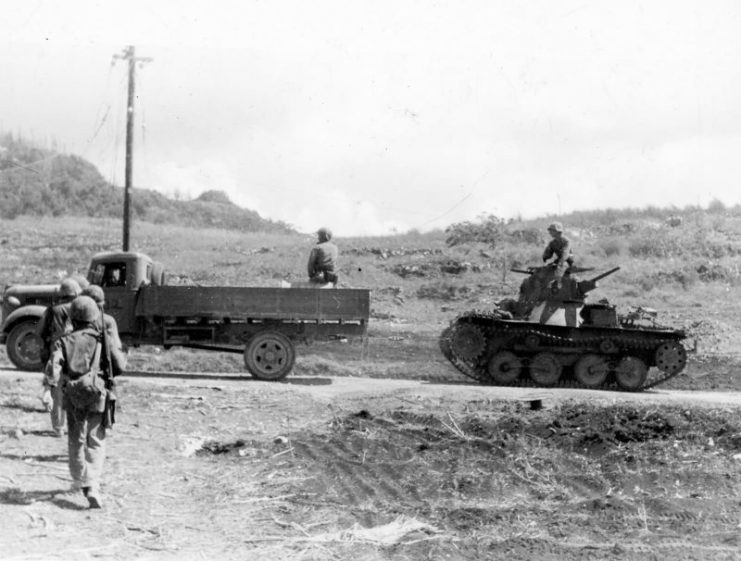 Marines use captured Japanese truck to tow Type 95 “Ha-Go” light tank, Saipan 1944