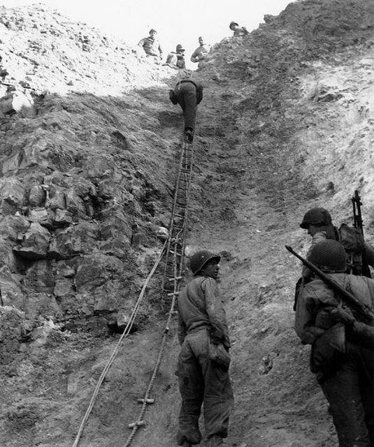 Normandy Invasion, June 1944 U.S. Army Rangers show off the ladders they used to storm the cliffs at Pointe du Hoc, which they assaulted in support of “Omaha” Beach landings on “D-Day”.