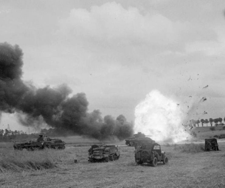 The British Army In The Normandy Campaign 1944. An ammunition lorry of 11th Armoured Division explodes after being hit by mortar fire during Operation ‘Epsom’