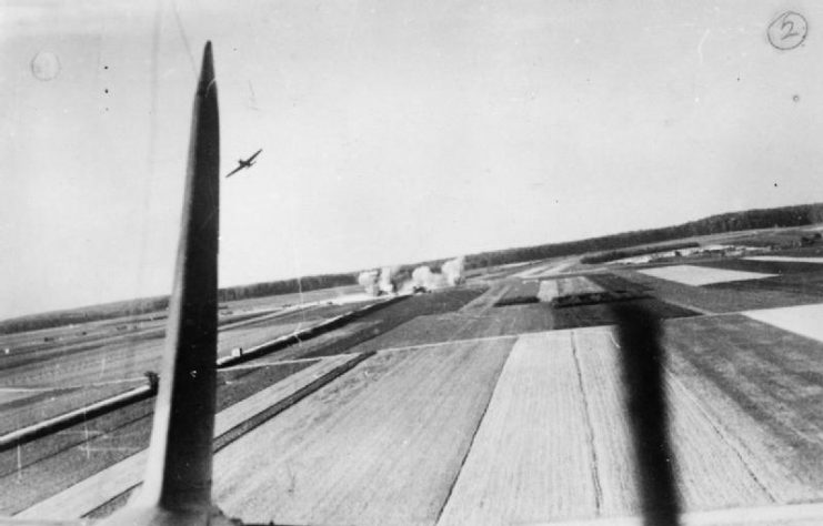 Royal Air Force- France, 1939-1940. Fairey Battles bombing a German horse-drawn convoy near Dunkirk. Photograph taken from the rear gunner’s position in a Battle as it cleared the target area.