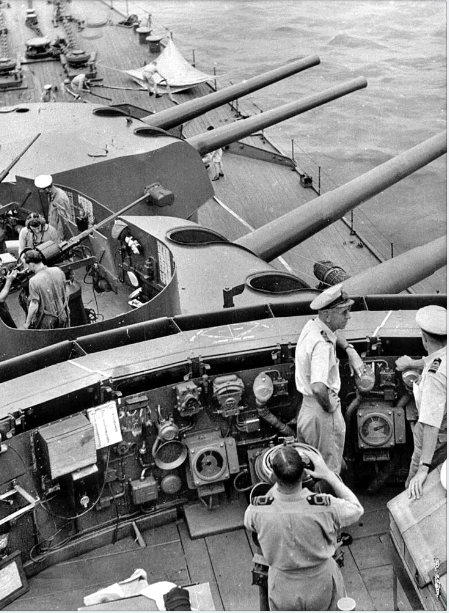 The bridge and forward superstructure of Australia in September 1944. This area was damaged when a Japanese bomber collided with the ship on 21 October 1944. Captain Emile Dechaineux (white uniform, facing right), was among those killed