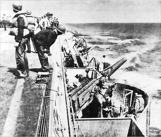 Damage in the port forward 127 mm gun gallery aboard the U.S. Navy aircraft carrier USS Lexington (CV-2), from a Japanese bomb that struck near the gallery’s after end during the Battle of the Coral Sea, 8 May 1942.