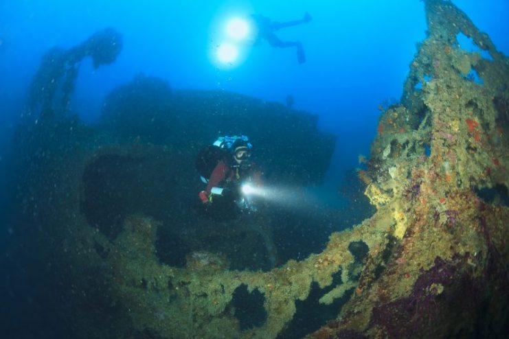 Scuba diver Exploring over a shipwreck.