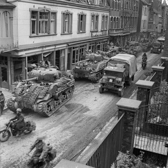 Sherman tanks and transport of 8th Armoured Brigade moving through Kevelaer, Germany, 4 March 1945.