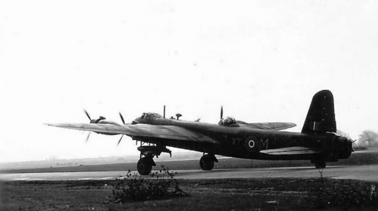 Short Stirling bomber sat on an airfield.