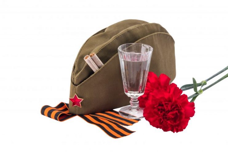 Soviet symbols of the War – Vodka, soldiers cap, red carnations, and St. George’s Ribbon