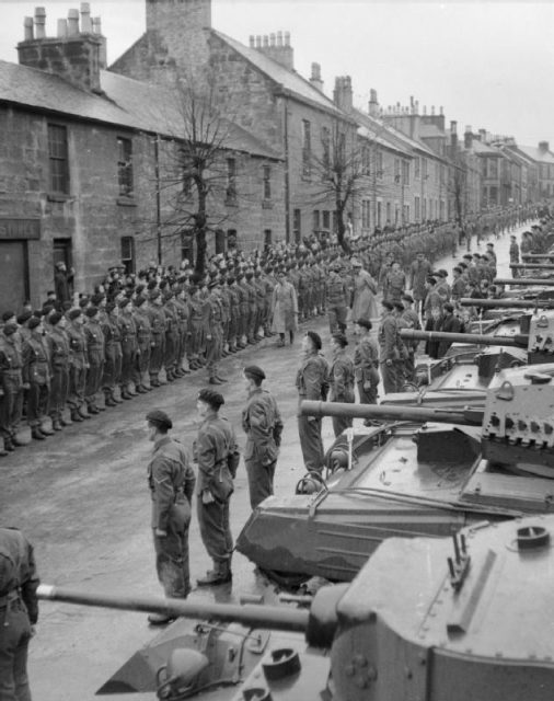 The King inspects a line-up of 26th Armoured Brigade Crusader tank crews in Scotland, 15 October 1942.