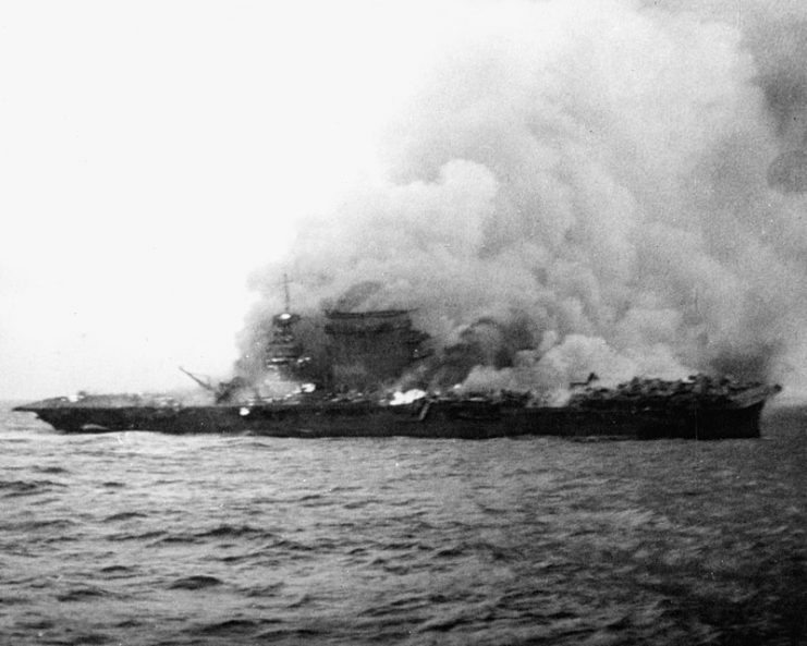 The U.S. Navy aircraft carrier USS Lexington (CV-2), burning and sinking after her crew abandoned ship during the Battle of the Coral Sea, 8 May 1942.